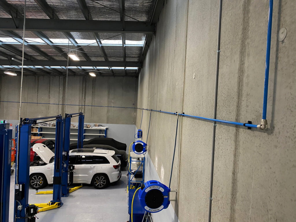 Compressed air pipe system complete with macnaught retracta hose reels and Kaishan Australia air compressor package.